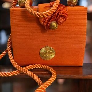 Vintage Satin Chanel style purse.Orange with cord strap, golden embellishments
